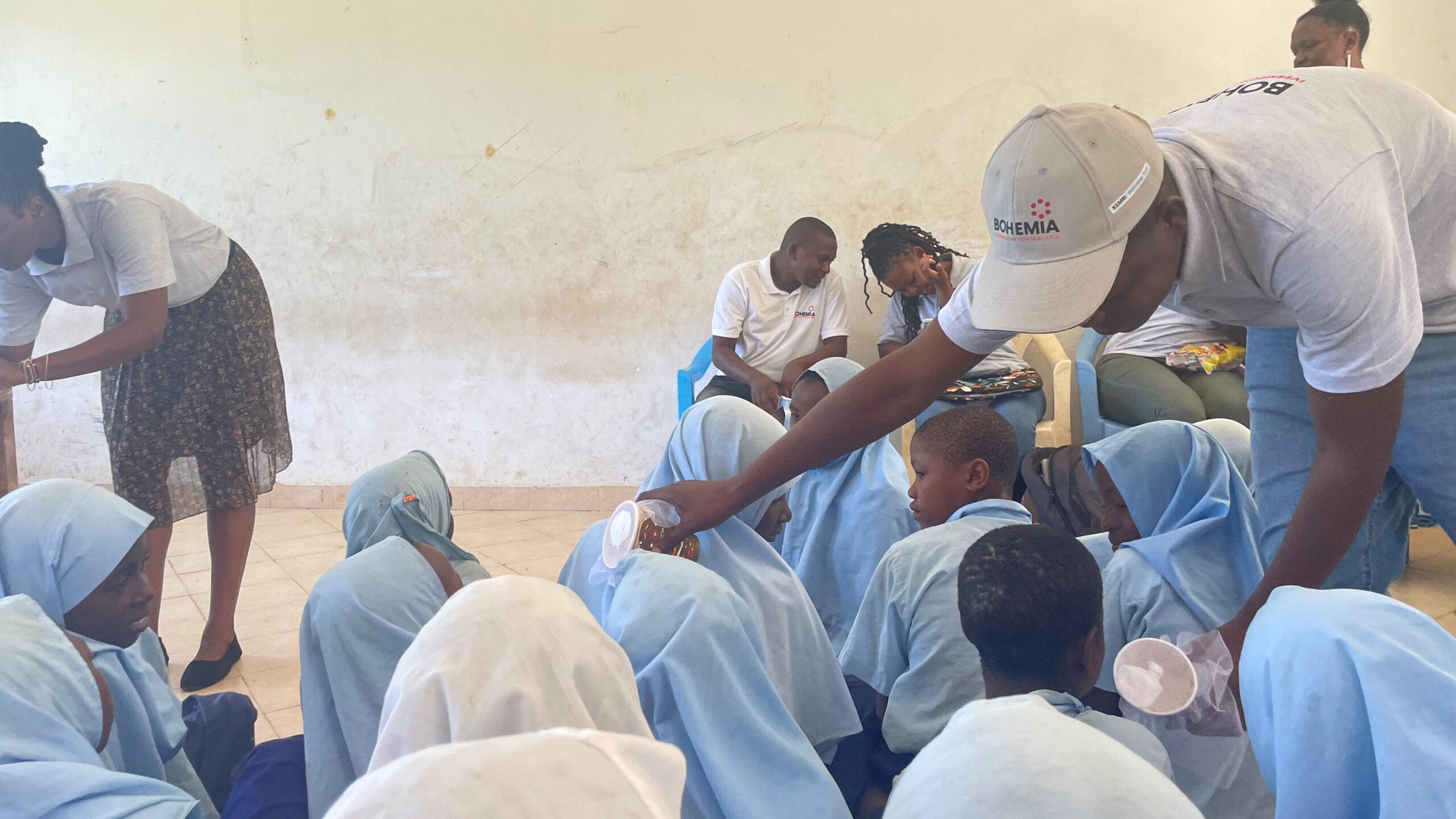 BOHEMIA project staff demonstrating mosquito samples to school students