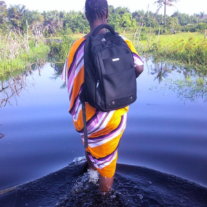 A BOHEMIA project fieldworker walking on a flooded street